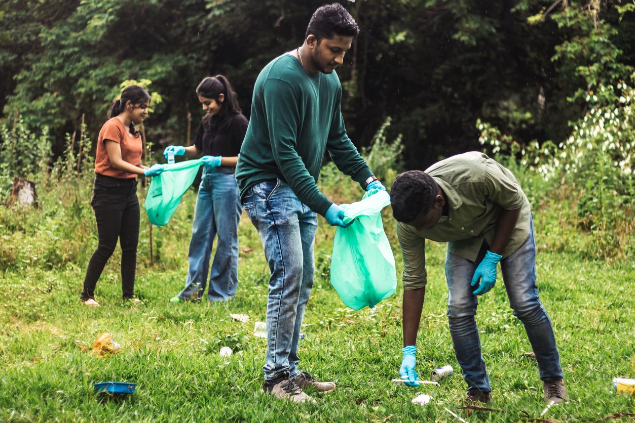 People Picking Up Trash in the Forest